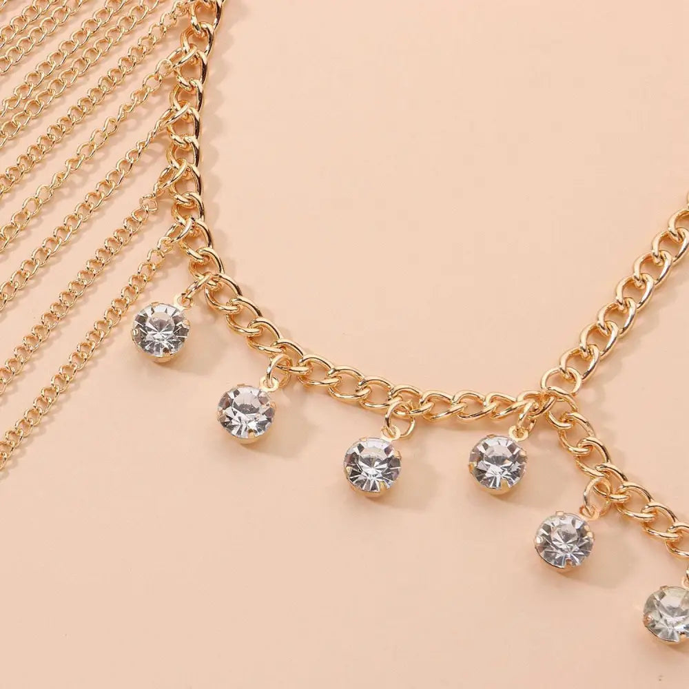 Gold crystal long tassel head chain featuring gold-toned body chain with dangling clear crystal charms for hair accessory