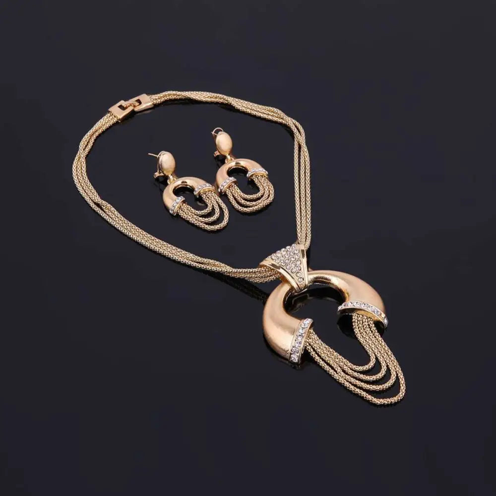 Gold electroplating alloy bridal jewelry set featuring a gold-toned necklace with crescent pendant and cascading chain strands