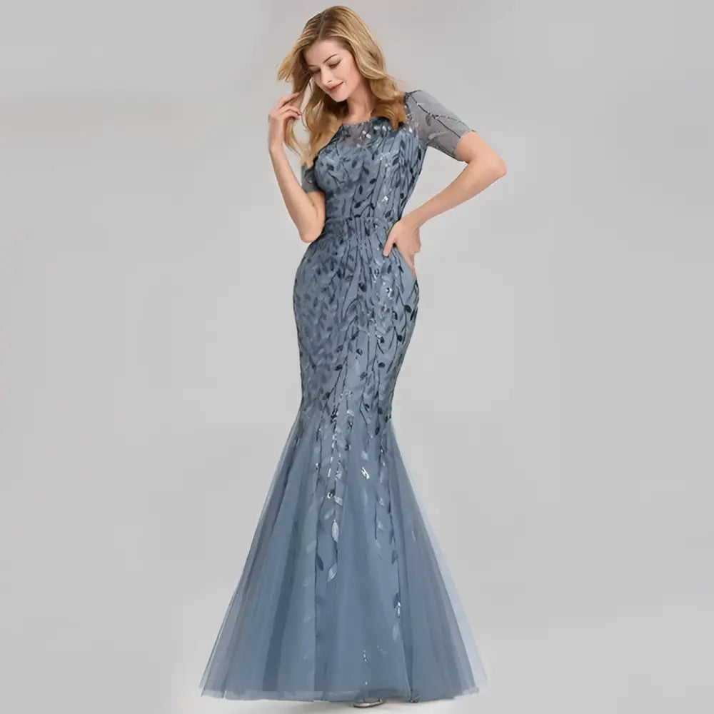 A sophisticated blue temperament mermaid dress featuring intricate gold embellished lace and sequin detailing with short sleeves