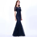 A navy blue temperament mermaid dress featuring intricate gold embellished lace, sequins, sheer short sleeves, and a flowing skirt