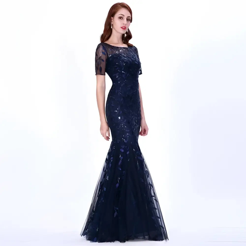 A navy blue temperament mermaid dress featuring intricate gold embellished lace, sequins, sheer short sleeves, and a flowing skirt