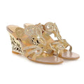 Gold embellished wedge sandals with intricate floral designs and sparkling rhinestone embellishments peep toe style