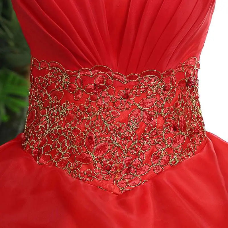 A vibrant large size red wedding dress with gold embroidered fitted bodice and tiered sheer tulle skirt