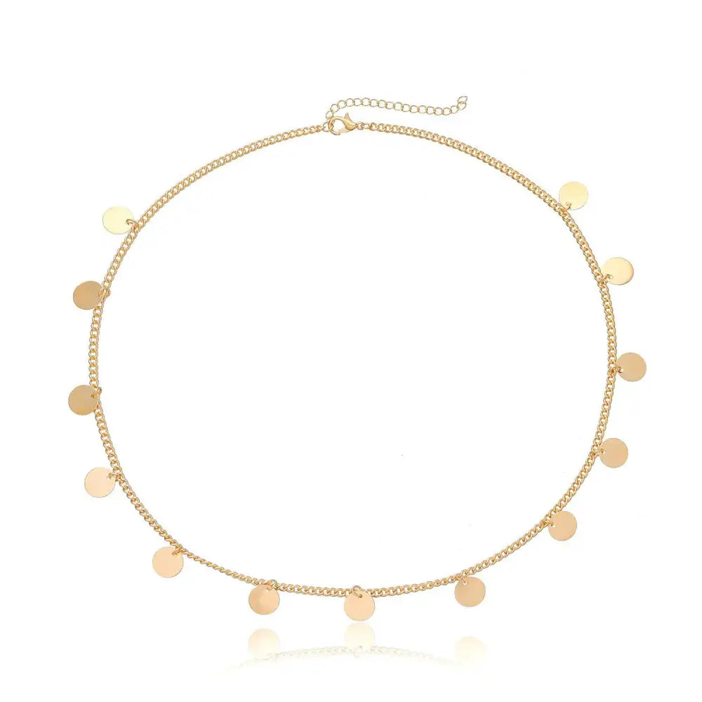 Gold-toned chain necklace with flat circular discs complementing the gold filigree pearl tassel headband hair accessory