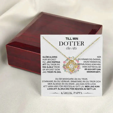 Gold floral knot daughter’s love necklace with a gold-toned pendant featuring a clear central stone in an ornate design