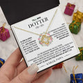 Gold floral knot daughter’s love necklace featuring a gold-toned floral design with clear gemstone in an elegant gift box