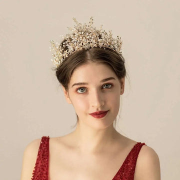 A gold floral rice rhinestone bridal headwear featuring delicate gold-toned tiara with intricate crystals and floral designs