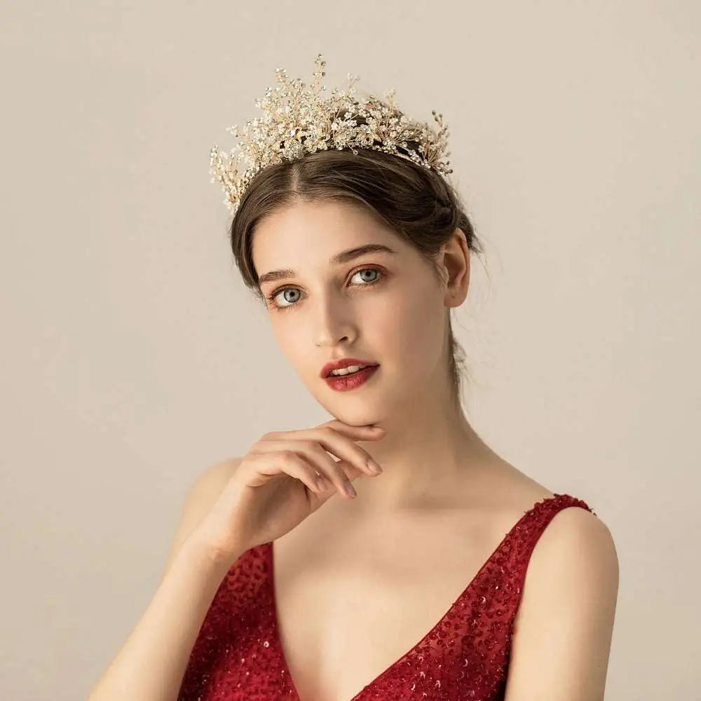 A gold floral rice rhinestone bridal headwear featuring delicate gold-toned tiara with intricate crystals and floral designs