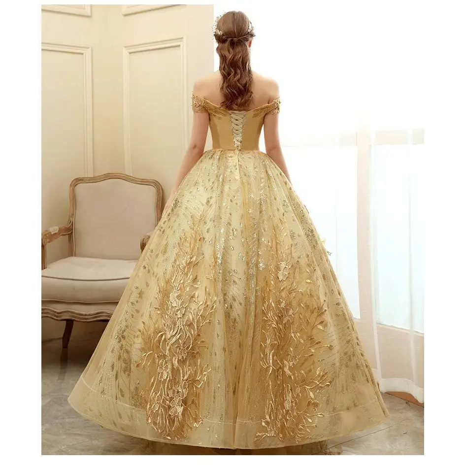 A shimmering gold floral solo performance off-the-shoulder tutu with intricate floral embroidery and voluminous tulle skirt