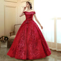 A vibrant red gold floral solo performance off-the-shoulder ball gown with intricate floral embroidery and voluminous skirt