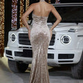A shimmering champagne gold floral velvet strapless halter banquet evening dress with intricate floral pattern