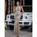A gold floral velvet halter banquet evening dress featuring an intricate floral pattern and shimmering velvet fabric