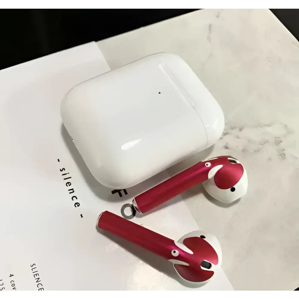 Red and white apple airpods 2 with gold glossy custom sticker skin featuring cartoon designs and matching charging case
