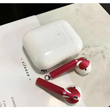 Red and white apple airpods 2 with gold glossy custom sticker skin featuring cartoon designs and matching charging case