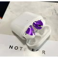 White apple airpods with purple metallic accents featuring a gold glossy custom sticker skin and matching charging case