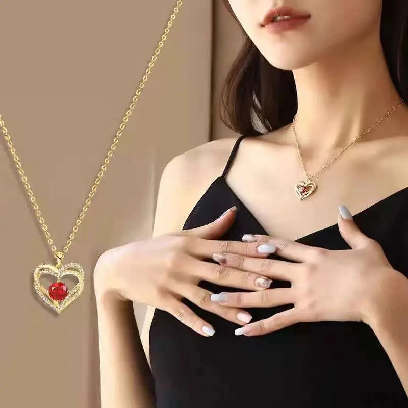 Gold heart red sapphire pendant necklace with a delicate chain and a red gemstone centerpiece in gold material