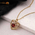 Gold heart red sapphire pendant necklace with central red gemstone surrounded by diamonds engraved with i love you