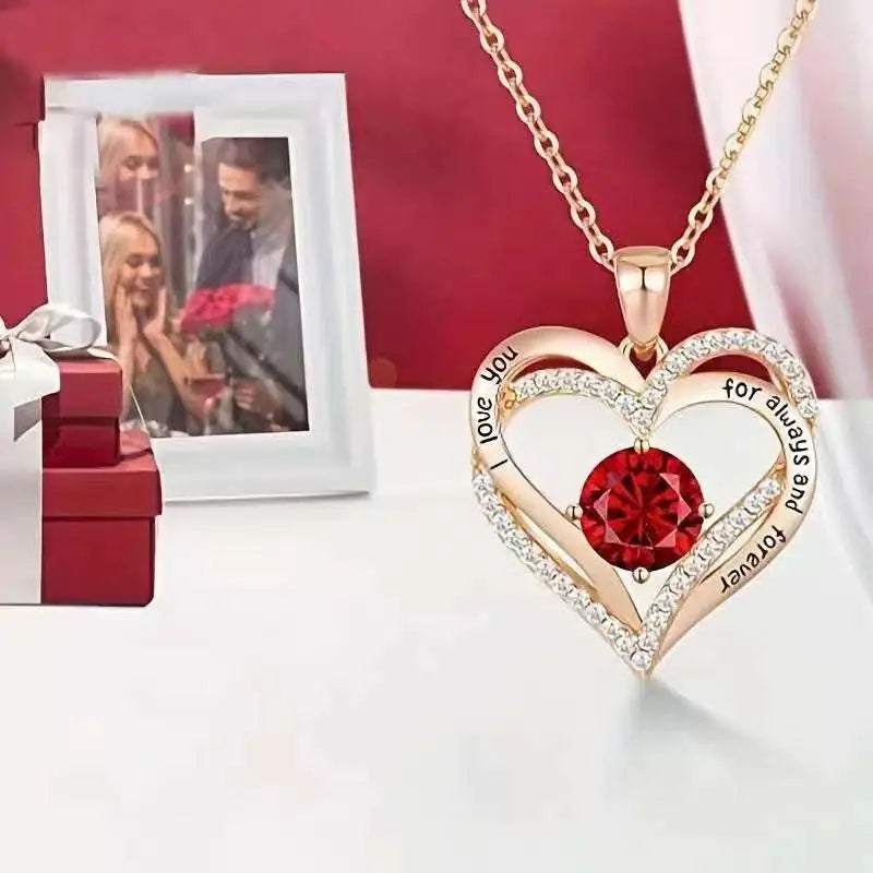 Gold heart red sapphire pendant necklace featuring a delicate chain and a red gemstone centerpiece