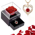 A gold heart red sapphire pendant necklace with a rose gold heart, red central gemstone, diamonds, and engraved message