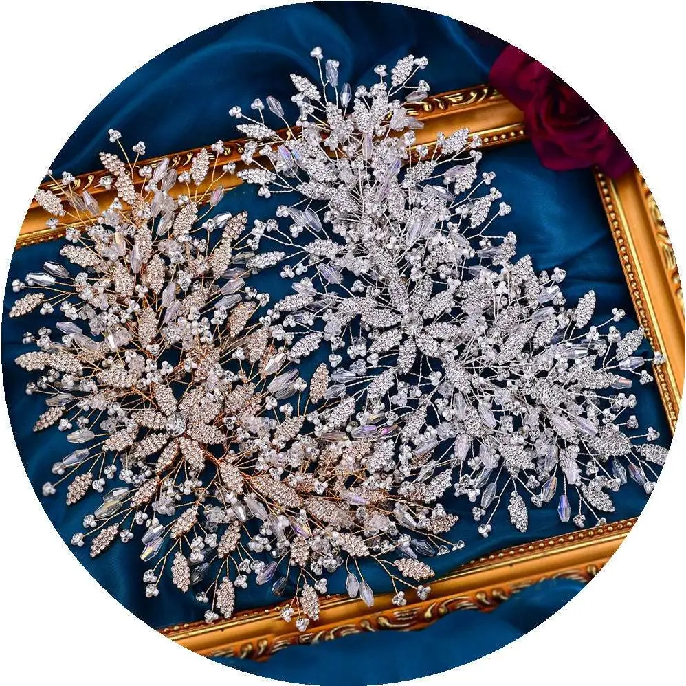 A gold luxurious exaggerated crystal leaf bridal headpiece with silver and gold crystal leaves, stems, and tiny beads