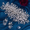 Silver crystal leaf bridal hair accessory with intricate branch design and purple-tinged rhinestones in luxurious exaggerated style