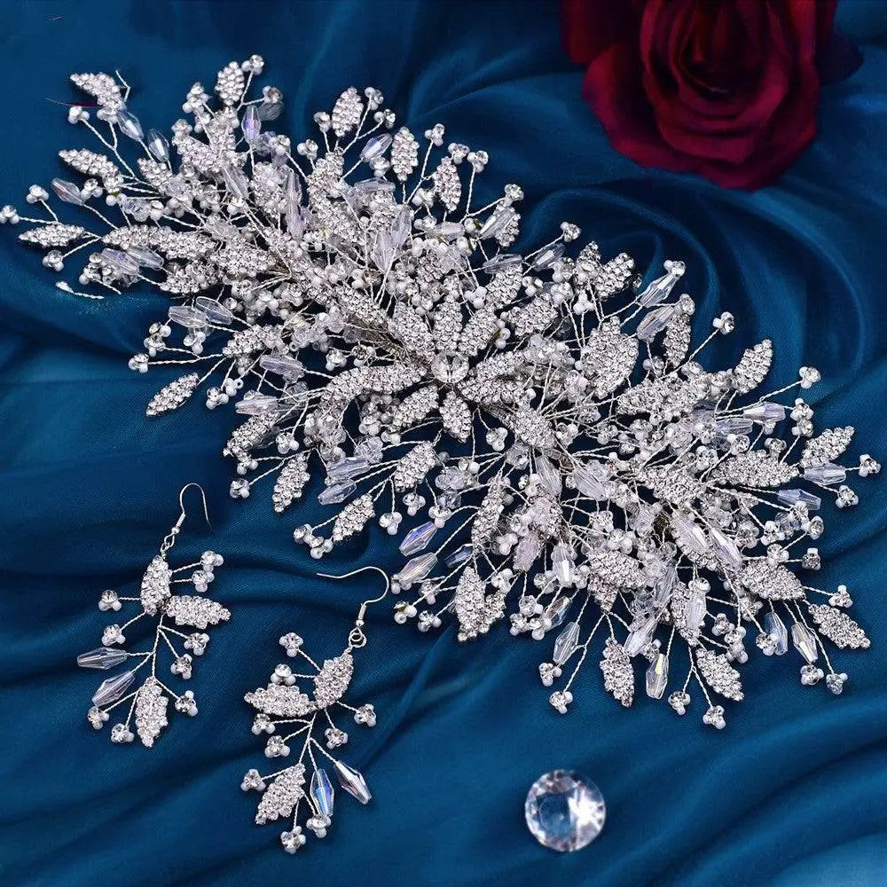 Silver crystal leaf bridal hair accessory with intricate branch design and purple-tinged rhinestones in luxurious exaggerated style