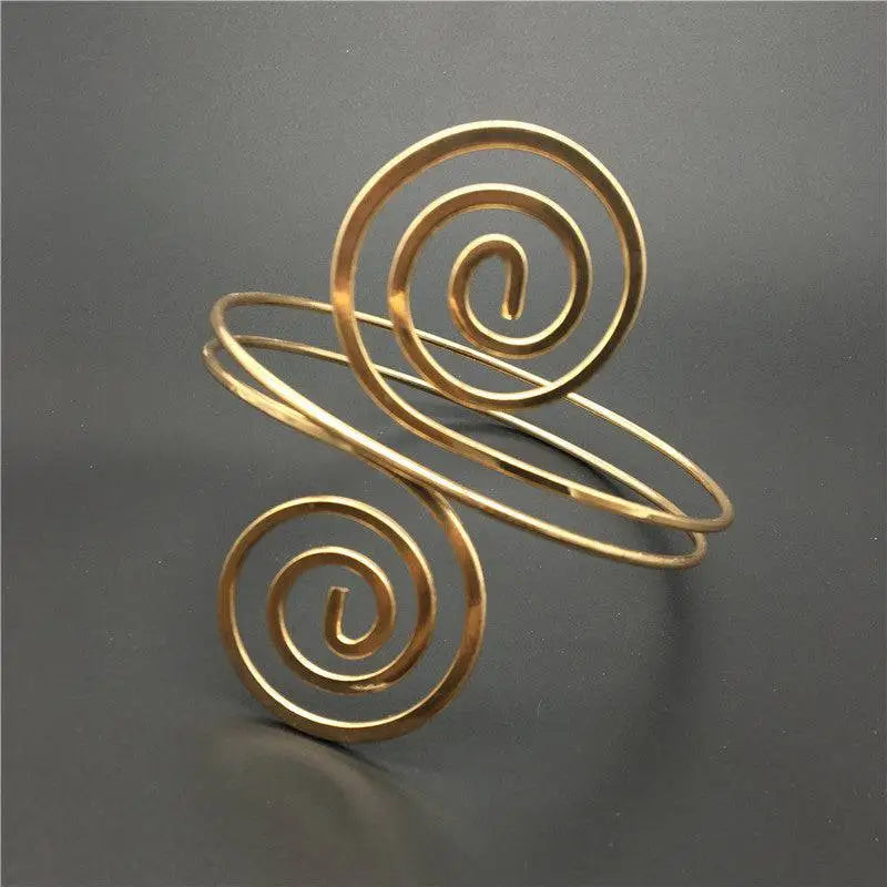 Gold-toned spiral arm ring featuring sleek minimalist design with elegant intertwined circular wire patterns in arm ring jewelry