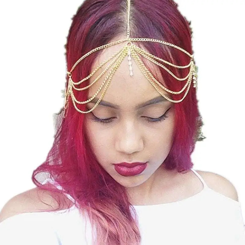 Gold multi layer diamond head chain featuring tassel inlaid diamond and a central dangling crystal detail