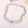 Silver multi-strand chain choker with delicate links and central clasp complementing gold multi layer tassel inlaid diamond head chain