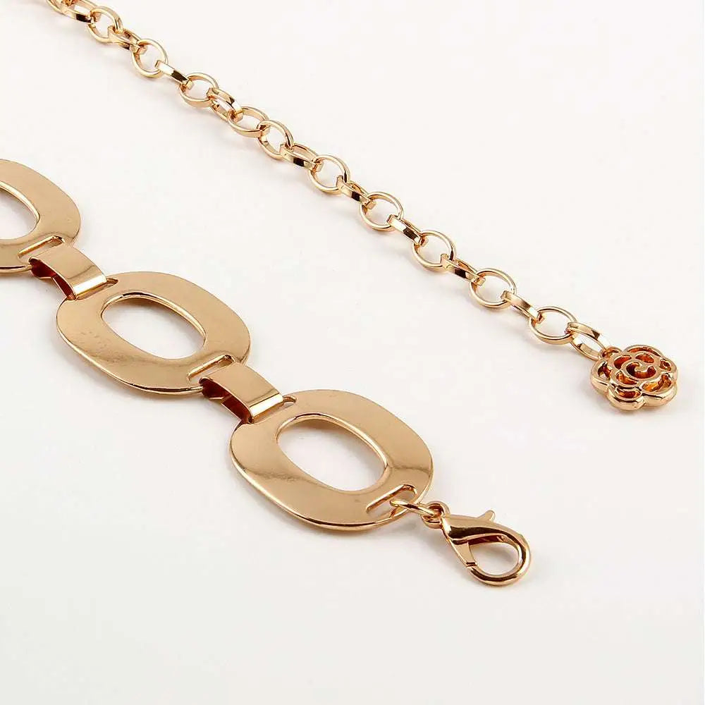 Gold-toned jewelry waist chain with oval links and a delicate rose charm perfect for summer jewelry waist looks