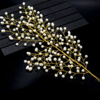 A delicate gold pearl branch outdoor hair comb with small white pearls in a leaf design for bride wedding use