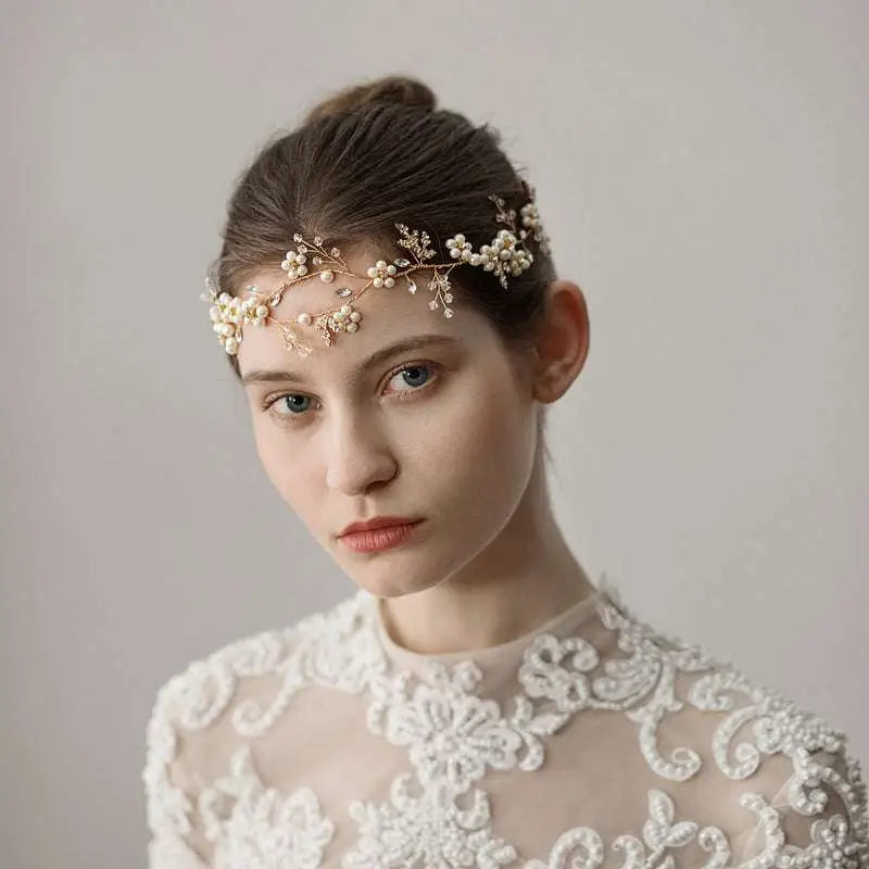 Delicate gold-toned pearl flower wedding headband adorned with small pearls and intricate floral detailing for bride