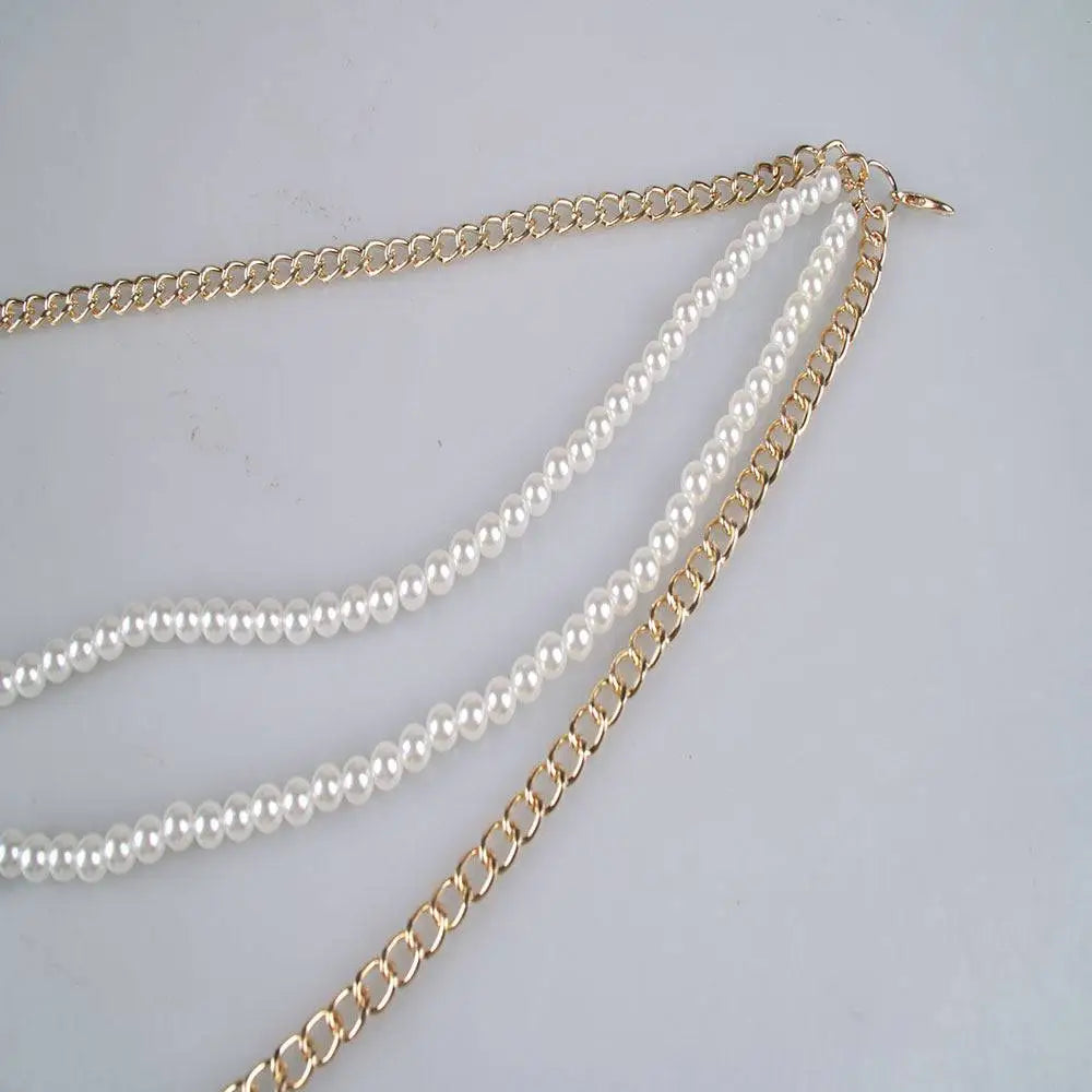 Gold-toned waist chain featuring two strands of white pearls woven between links as elegant pearl jewelry accessories