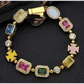 Gold plated hip-hop gemstone bracelet set with gold tone, colorful rectangular and oval stones, and pink cross charms