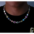 A vibrant multi-colored hip-hop gemstone necklace and bracelet set with gold plated metal and cross-shaped charms