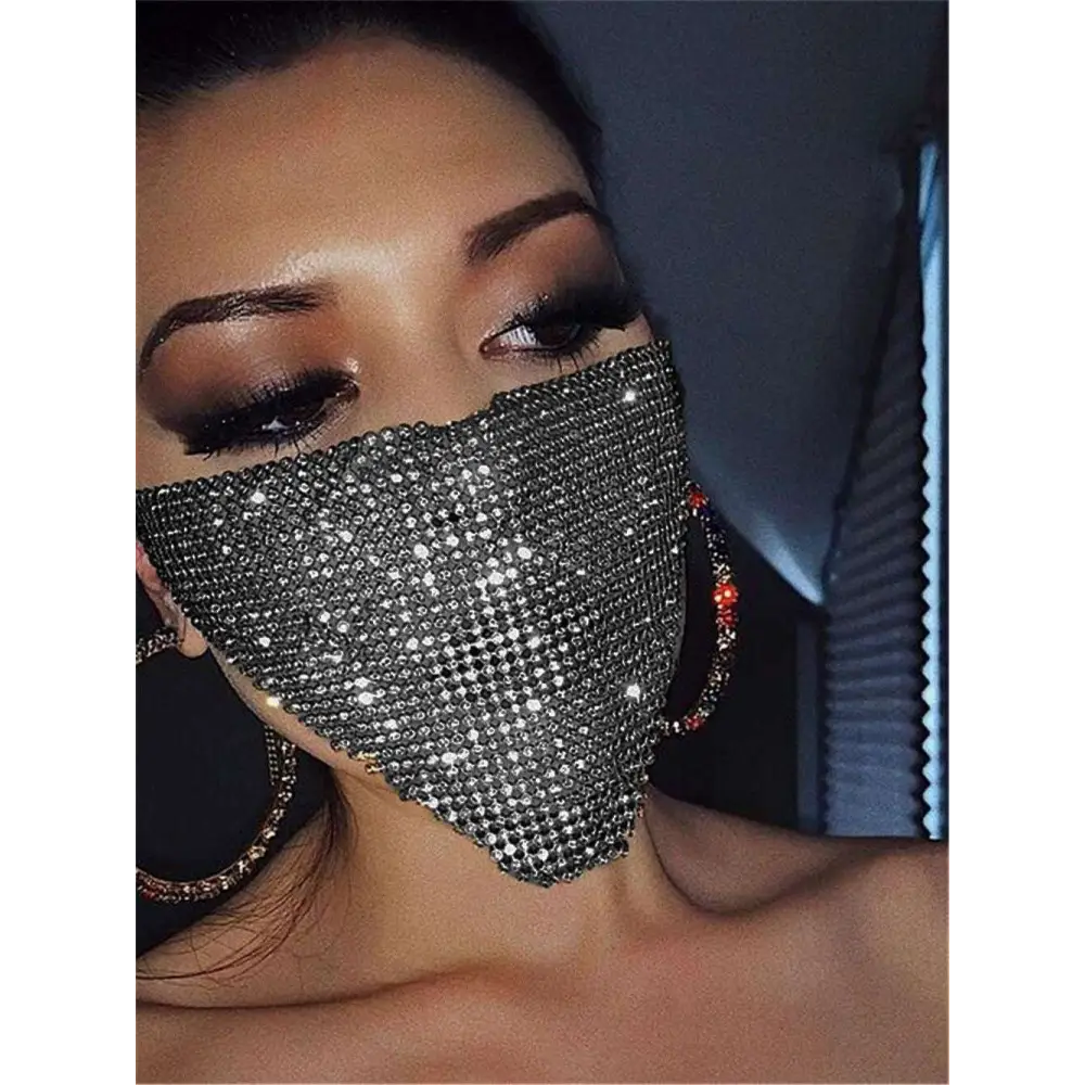 A sparkling silver flash jewelry mask adorned with dense gold rhinestone crystals for explosive metal flash style