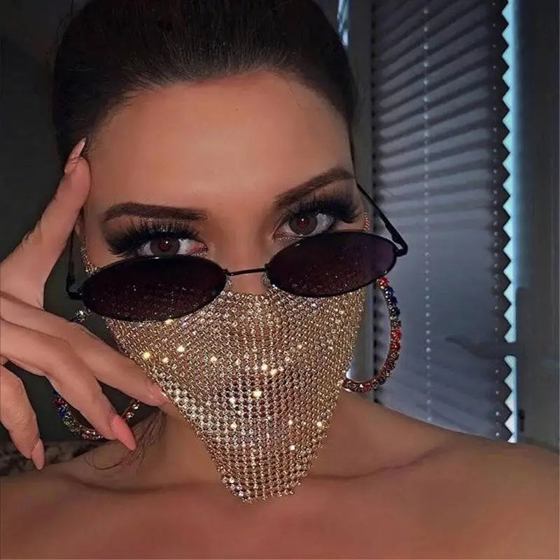 A gold rhinestone explosive metal flash jewelry mask with a shimmering mesh design worn over nose and mouth
