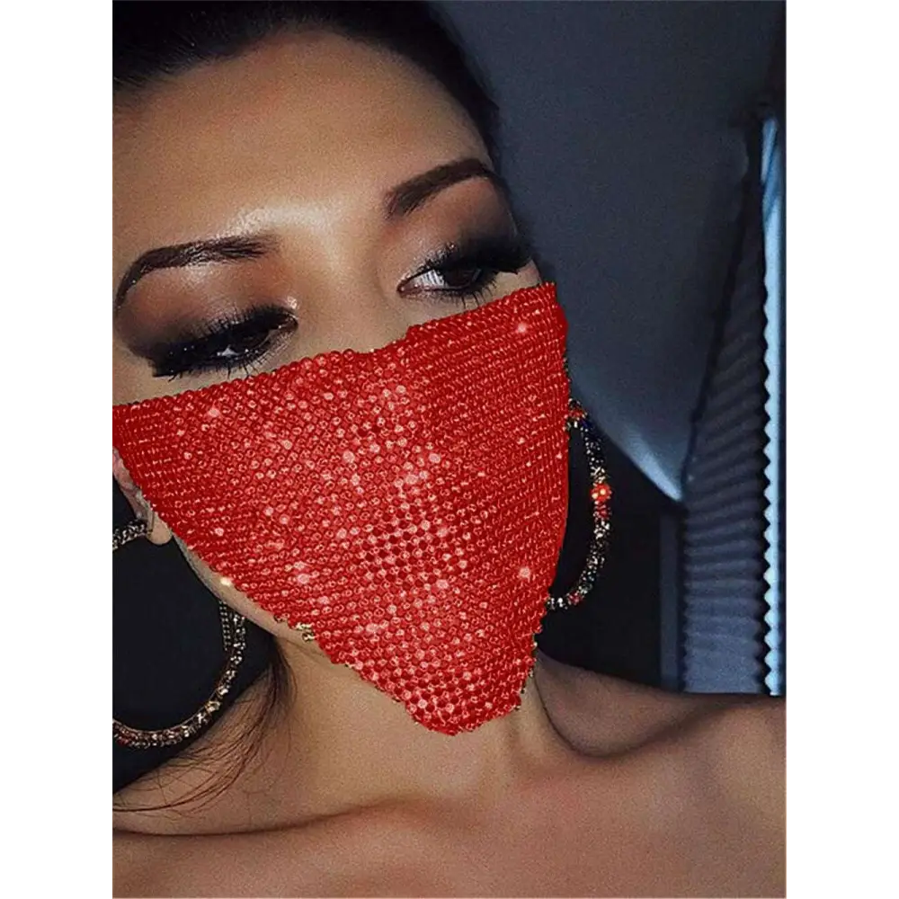 A dazzling red explosive metal flash jewelry mask with dense sparkling gold rhinestone embellishments