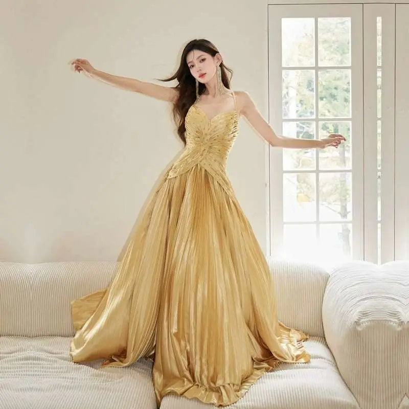 A shimmering gold satin gown with fitted bodice and flowing pleated skirt for heavy industry birthday dress
