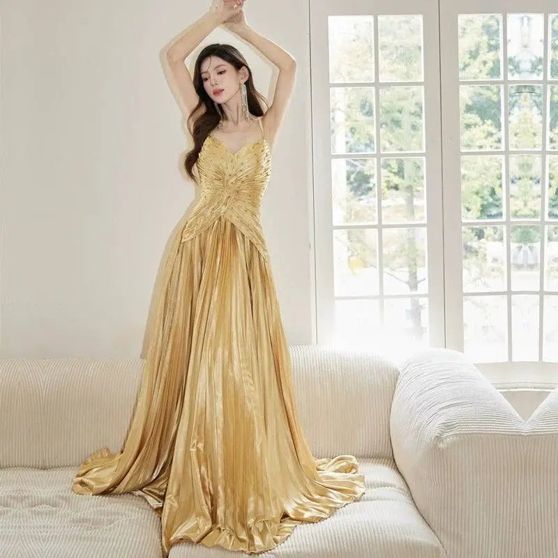 A shimmering gold satin gown with fitted bodice and flowing pleated skirt for heavy industry birthday dress