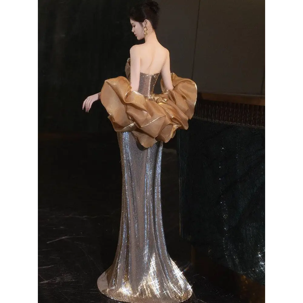 A silver sequined temperament evening dress with a dramatic gold satin ruffle for gold sequined banquet events