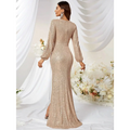 A shimmering gold sequined long sleeve evening gown with high slit fishtail design and high neckline
