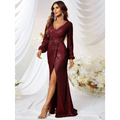 A shimmering burgundy sequined long sleeve evening gown with high slit fishtail design