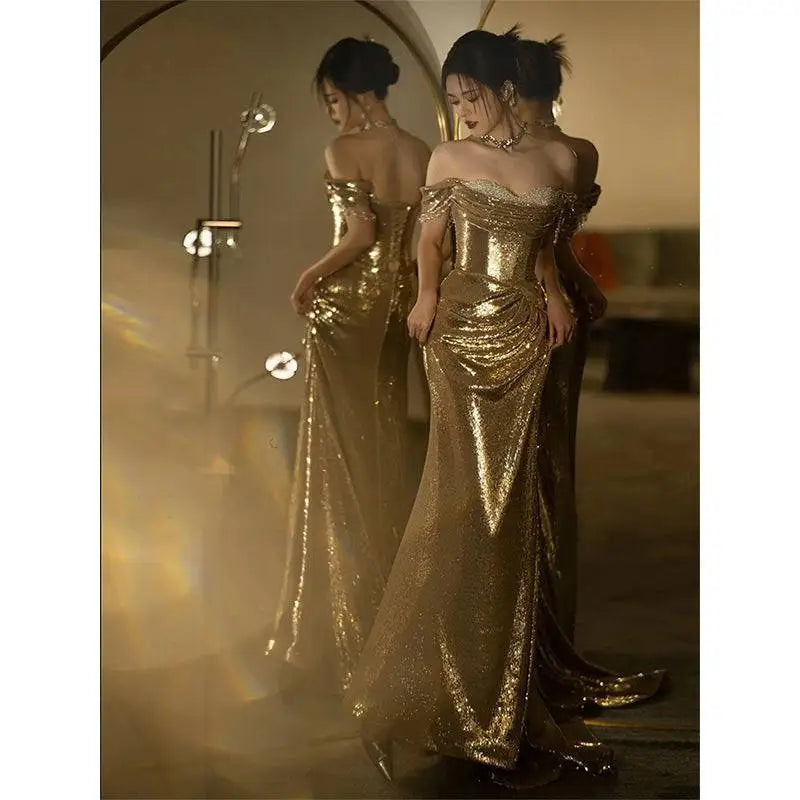 Gold sequined off-shoulder dress bridal fishtail gown with fitted bodice and flowing skirt for elegant occasions
