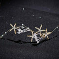 Gold-toned starfish pearl hair accessory adorned with sparkling crystals and white pearls for elegant styling