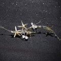 Gold-toned starfish pearl hair accessory with delicate pearls and sparkling crystals detailed with fine chains