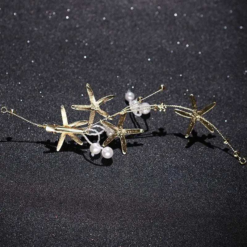 Gold-toned starfish pearl hair accessory with delicate pearls and sparkling crystals detailed with fine chains
