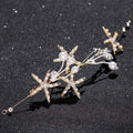 Delicate gold-toned starfish pearl hair accessory adorned with pearls and sparkling crystals for elegant styling