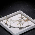 Gold-toned starfish pearl hair accessory adorned with sparkling crystals and dangling white pearls for elegant styling