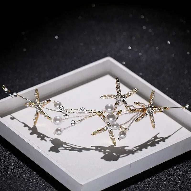 Gold-toned starfish pearl hair accessory adorned with sparkling crystals and dangling white pearls for elegant styling